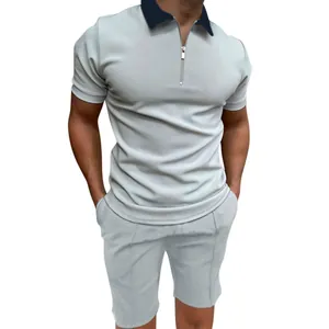 Close-up of men's grey slim fit polo shirt with navy collar and matching shorts
