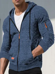 Detail view of men's blue jacquard knitted hoodie with full zip and orange accents