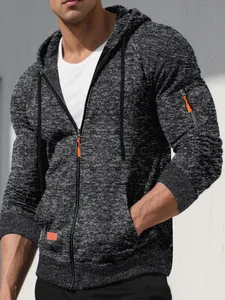 Macro view of a men's athletic charcoal jacquard zip-up hoodie with orange accents
