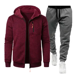 Detailed view of men's burgundy hooded jacket and grey knit joggers tracksuit set