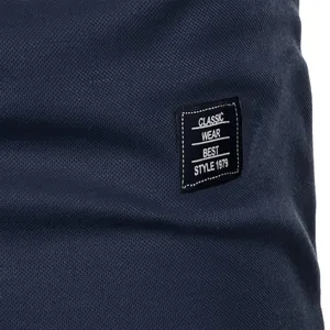 Close-up detail of navy blue breathable mesh fabric with embroidered classic wear patch