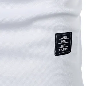 Macro detail of white textured men's t-shirt with black 'Classic Wear' stitched patch