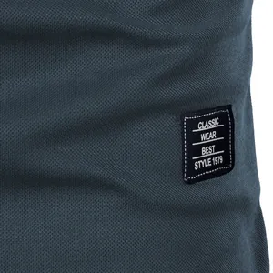 Macro view of mesh fabric texture and woven classic style label on men's blue top