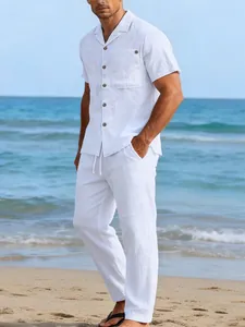 Model wearing white linen casual shirt and pants set standing on a sunny beach