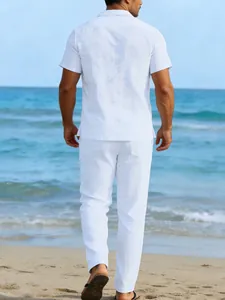 Back view of a white linen short sleeve shirt and matching pants on a beach