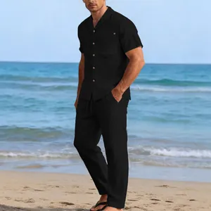 Casual black linen two-piece set with short sleeve shirt and long pants on a beach