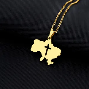 Close-up of gold Ukraine map pendant with cross cutout on a polished O-chain link