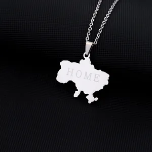 Macro shot of silver stainless steel necklace with Ukraine map and HOME engraving