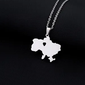 Macro detail of silver stainless steel Ukraine map pendant with a heart cutout detail