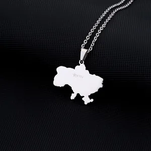 Macro detail of silver Ukraine map necklace with Kyiv engraving and star icon