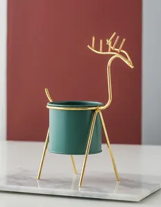 Detail showing Nordic reindeer metal plant stand with an elegant gold finish