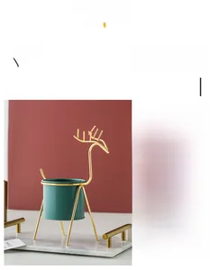 Detail showing Nordic reindeer metal plant stand with an elegant gold finish