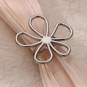 Detail view of a creative hollow five-petal daisy ring crafted in silver titanium steel