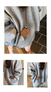 Vintage brown suede mini crossbody bag shown as a stylish accessory on a grey sweater