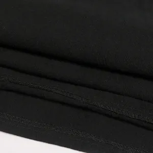 Macro close-up of premium black fabric texture and durable stitching on Renaissance shirt