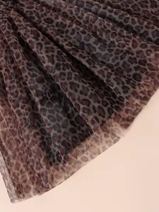Close-up detail of the lightweight leopard print mesh tulle fabric on a girls dress