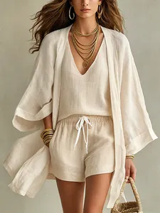 Close-up of three-piece cotton linen set featuring long cardigan and V-neck vest