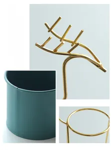 Close-up details of Nordic gold-plated iron flower stand with a dark green pot