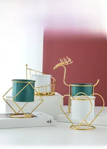 Nordic minimalist gold iron frame ceramic flower pots in various geometric shapes.