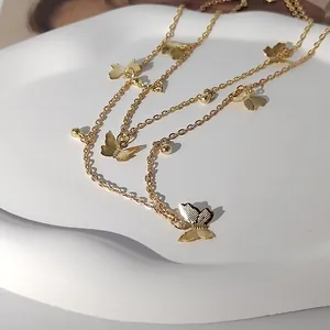 Elegant golden double-layered necklace featuring delicate butterfly charms and beads