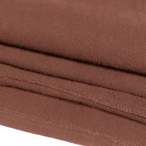 Close-up macro view of the brown cotton fabric and seam detail of a medieval shirt