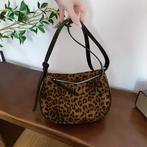 Detailed view of the leopard print matte underarm bag with a stylish crescent shape.