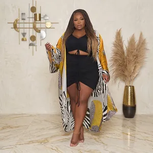 Elegant plus-size women's printed long kimono jacket paired with black ruched mini dress.
