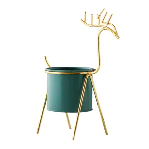 Nordic style minimalist deer-shaped gold iron plant stand with a dark green pot