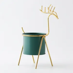 Nordic style minimalist deer-shaped gold iron plant stand with a dark green pot