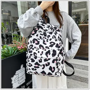 Stylish casual backpack with leopard print worn by a young woman in a city street