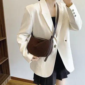 Minimalist brown suede crescent crossbody bag for women with an adjustable strap