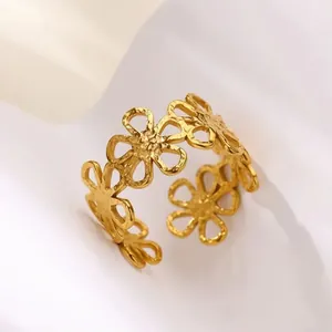 Detailed macro shot of a gold-plated titanium steel daisy hollow-out open ring