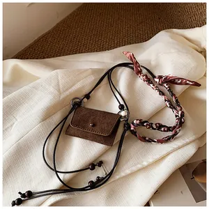 Retro brown suede mini purse detail with knotted silk scarf and beaded cord strap
