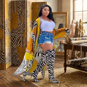 Detailed view of long print kimono cardigan with zebra pattern and matching boots