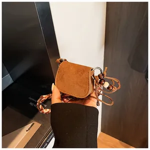 Vintage brown suede mini crossbody coin purse for women with decorative beads and cord strap