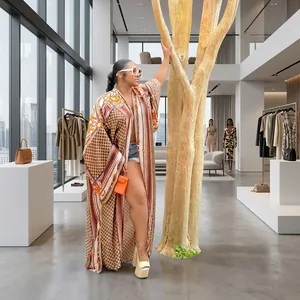 Full view of a stylish long loose printed kimono cardigan for women in outdoor garden