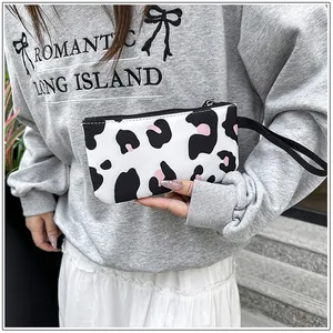 Handheld leopard print wristlet pouch with black zipper detail for stylish daily use