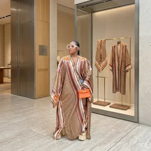 Detail showing women's autumn printed loose kimono windbreaker in an outdoor setting