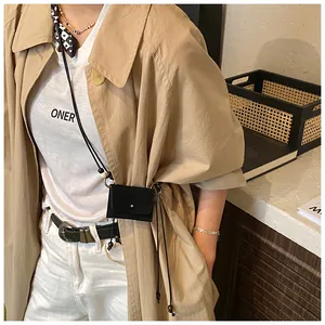 Detailed lifestyle view of a retro black suede mini crossbody coin purse for women
