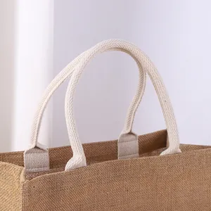 Close-up view of a durable natural jute tote bag featuring thick cotton rope handles
