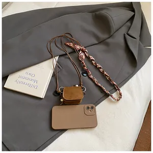 Detail shot of a vintage brown suede mini coin purse on a grey blazer background