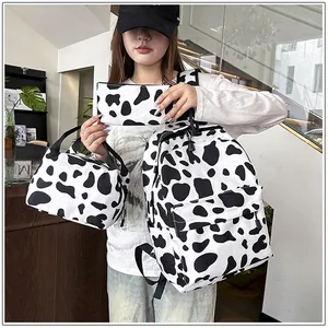 Three-piece set including cow print backpack, handbag and pencil case