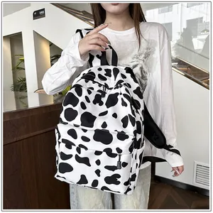 Stylish black and white cow print backpack for students in a modern indoor setting