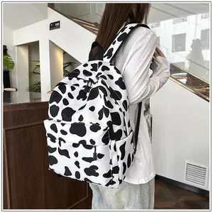 Modern casual cow print backpack for students shown from a rear perspective view