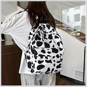 Fashionable cow print backpack for students shown in a real-life campus setting