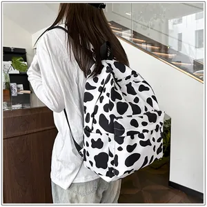 Student casual cow print backpack being worn in a modern indoor lifestyle setting