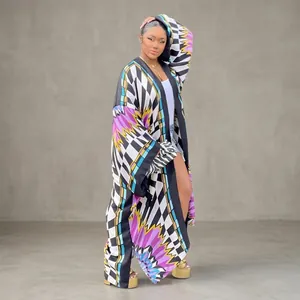 Model wearing autumn loose casual printed kimono windbreaker against green hedge