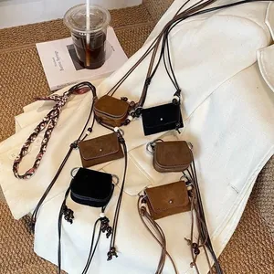 Set of vintage suede mini crossbody coin purses in black and brown colors for women