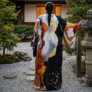 Back view of a long loose kimono with bold abstract orange and black floral prints