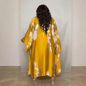 Back view of an elegant long yellow floral print kimono robe featuring loose casual sleeves